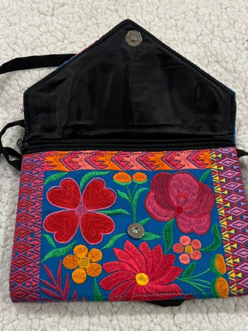 Small embroidered purse with floral pattern design.
